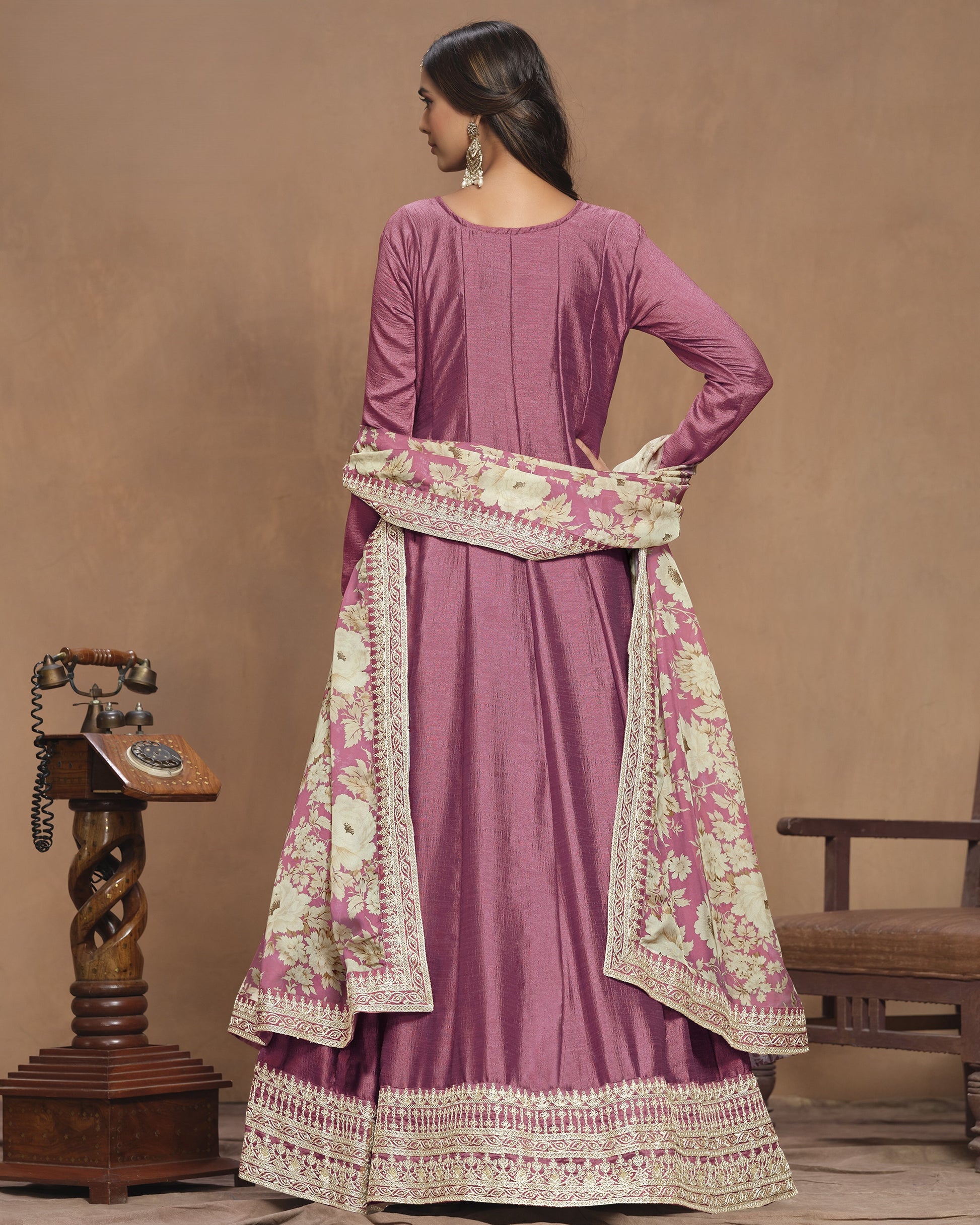 Purple traditional outfit with floral patterns on a brown background