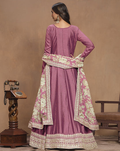 Purple traditional outfit with floral patterns on a brown background