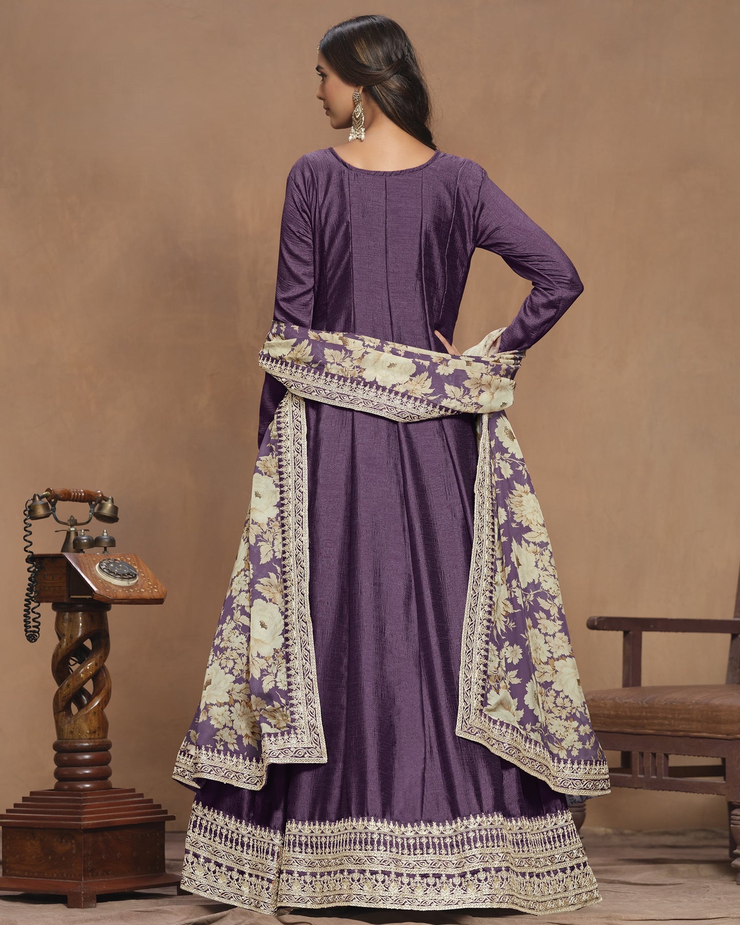 Purple traditional outfit with floral patterns on a brown background