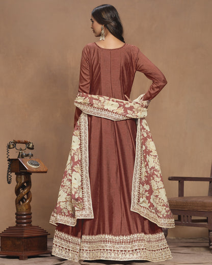 Woman wearing a brown traditional outfit with floral patterns in a vintage setting.