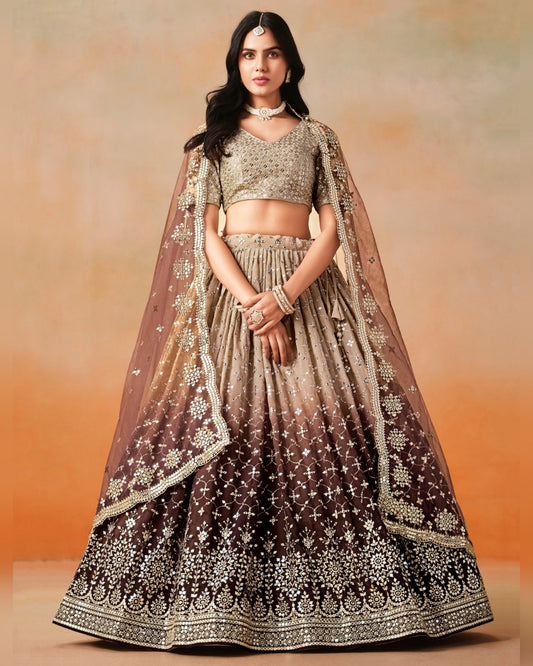 Woman wearing a traditional outfit with a brown and beige lehenga against an orange background