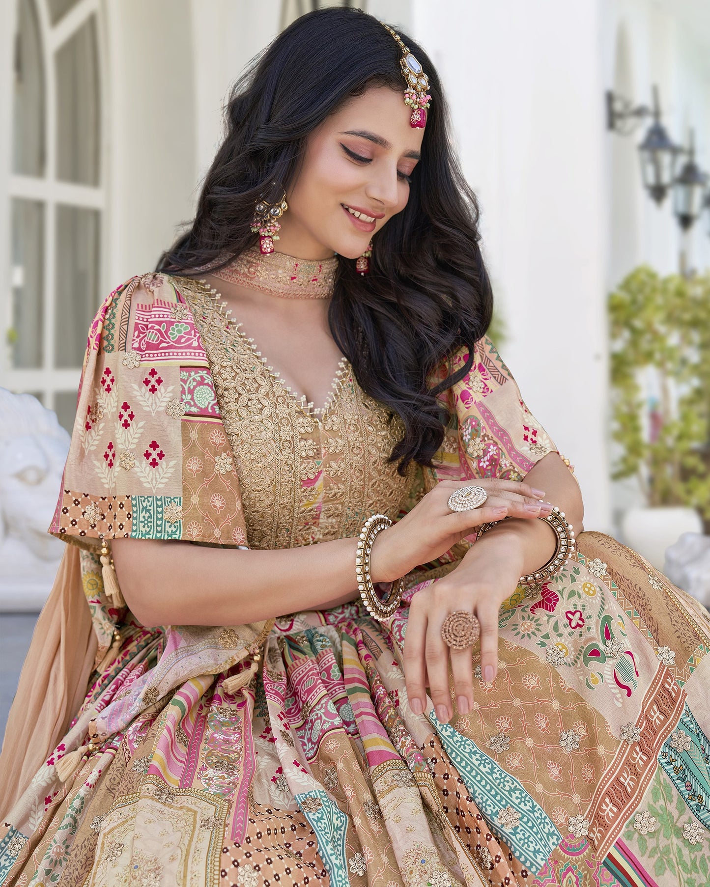 Woman in traditional embroidered outfit with jewelry, outdoor setting