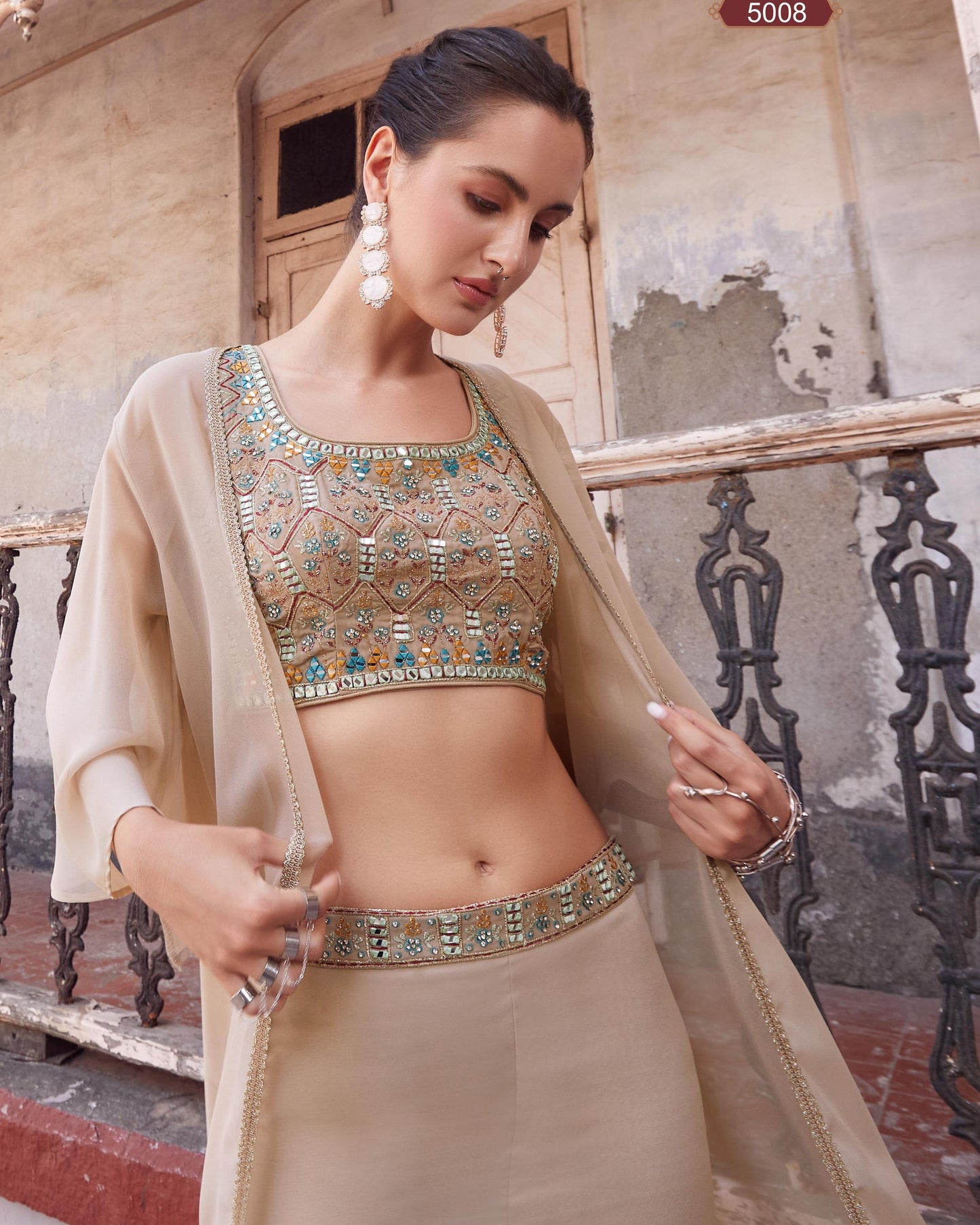Woman wearing a traditional outfit with intricate designs in an outdoor setting