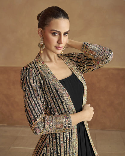 Woman wearing an ornate, patterned jacket against a beige background