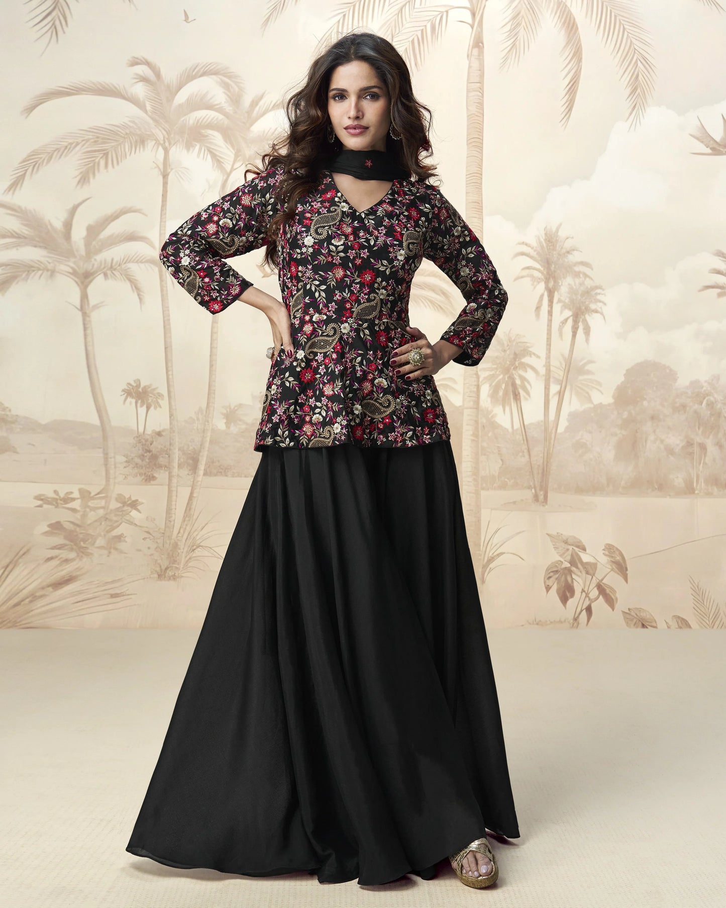 Woman wearing a floral top and black skirt with a palm tree background