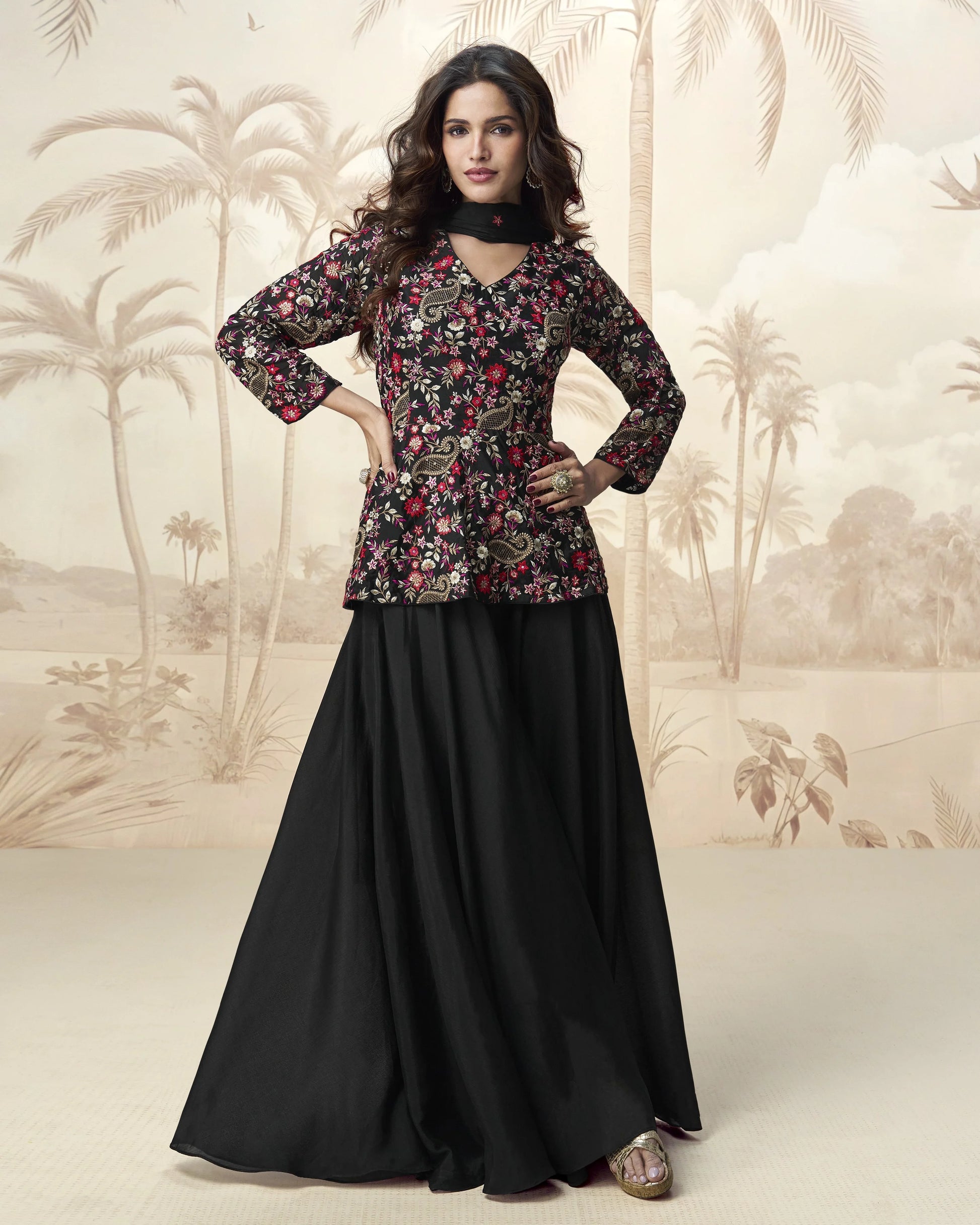 Woman wearing a floral top and black skirt with a palm tree background