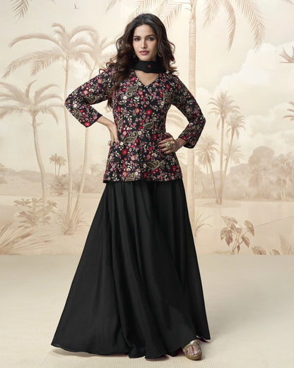 Woman wearing a floral top and black skirt with a palm tree background