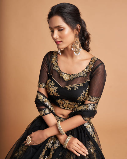 Woman wearing a black and gold embroidered traditional outfit on a beige background