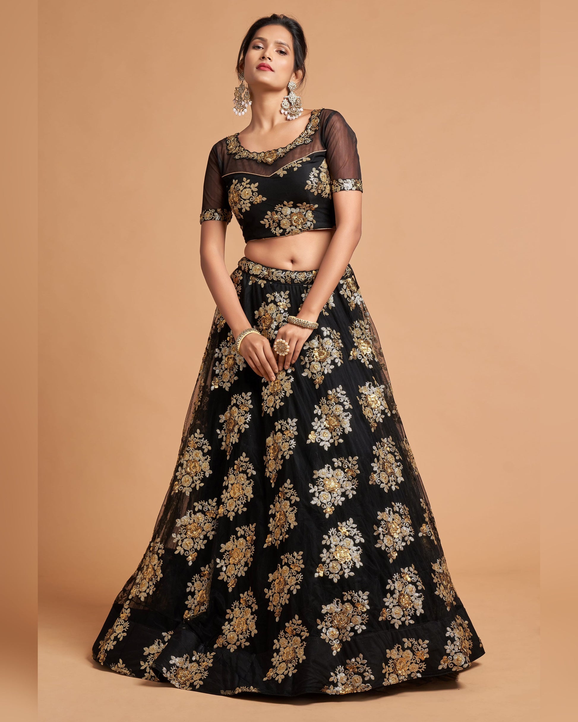 Woman wearing a black and gold embroidered traditional outfit on a beige background