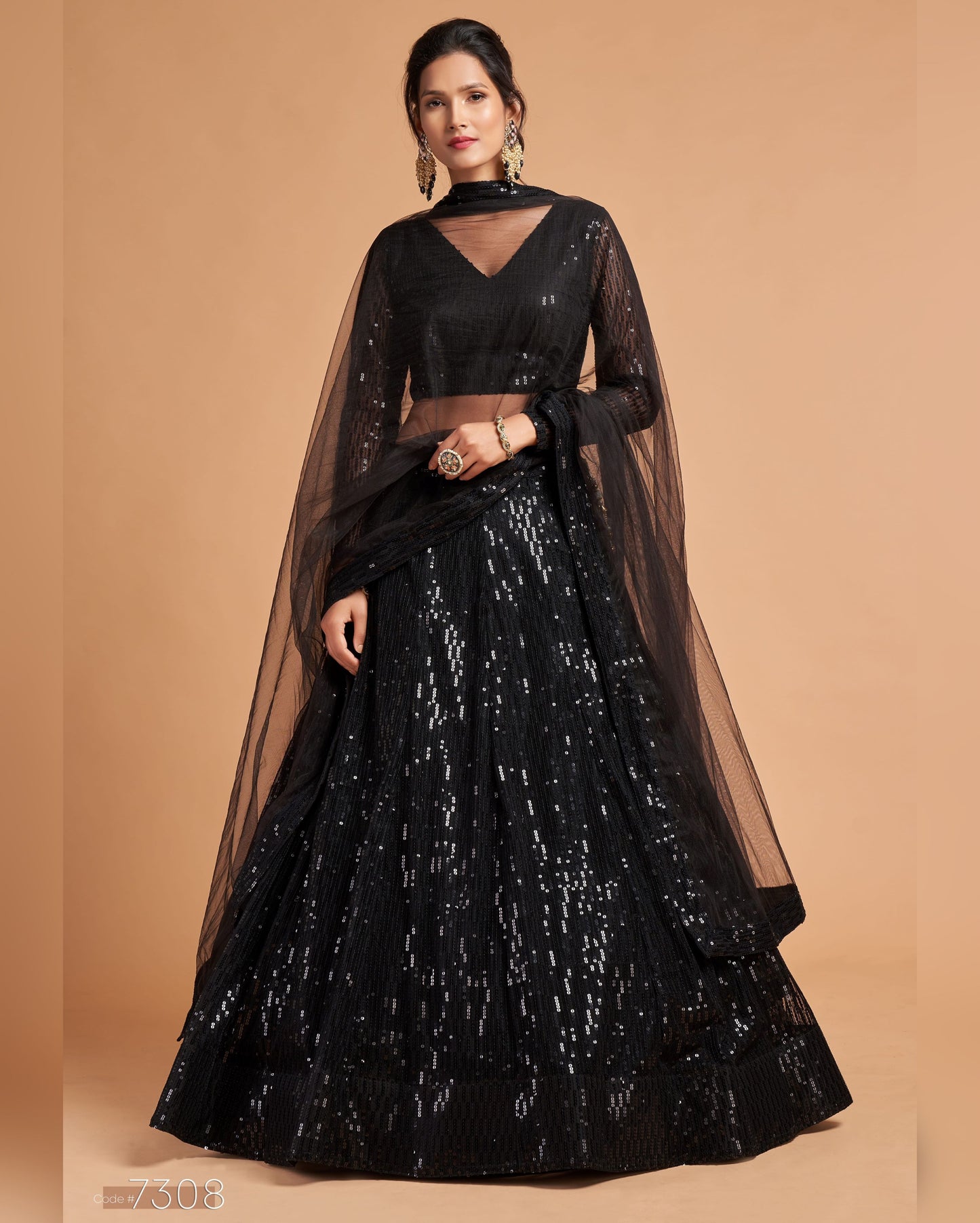 Black traditional outfit with a sheer overlay on a beige background