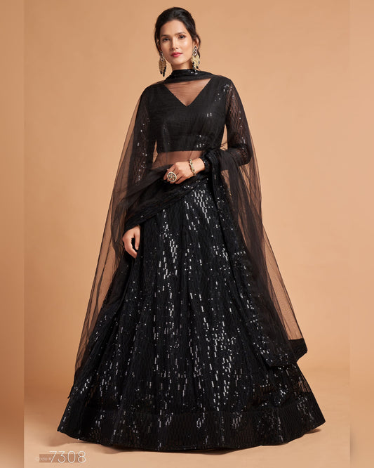 Black traditional outfit with a sheer overlay on a beige background