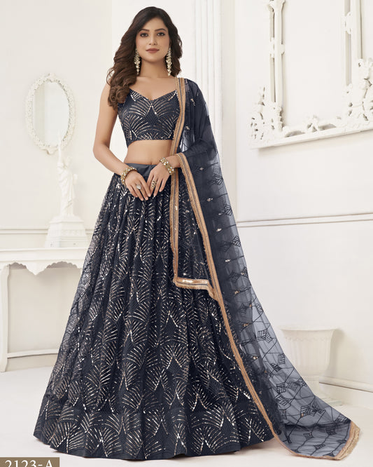 Woman wearing a black and white patterned lehenga with a beige dupatta on a white background