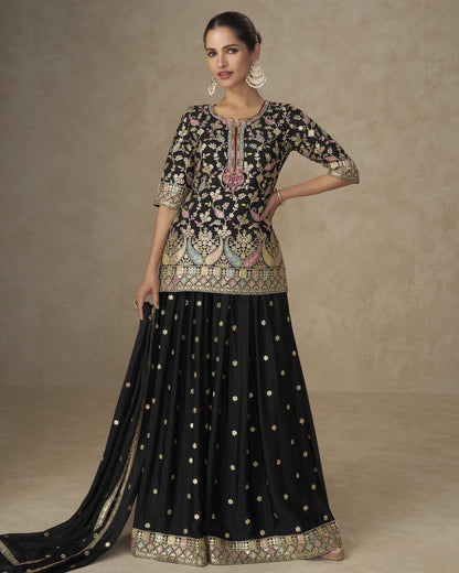 Woman wearing a traditional outfit with intricate patterns on a plain background