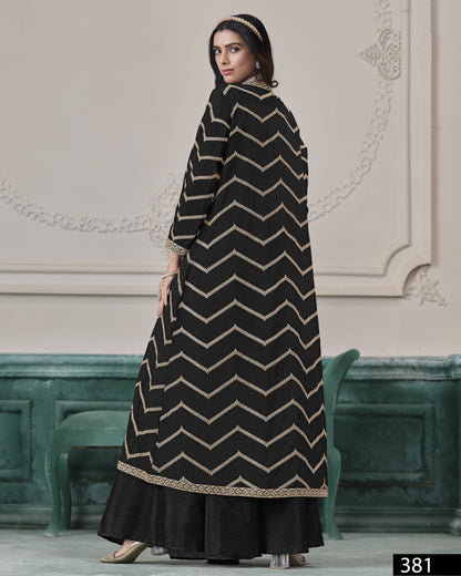 Woman wearing a black and beige chevron patterned dress in an elegant interior setting.