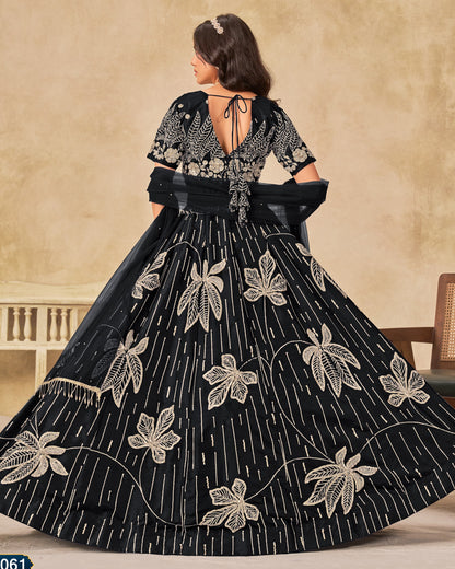 Black embroidered dress with floral patterns on a beige background