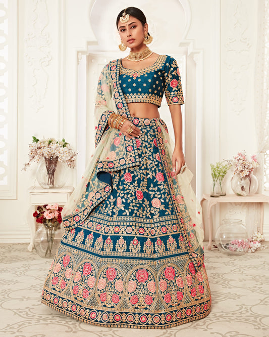 Woman in a traditional embroidered outfit with floral patterns in a decorated room.