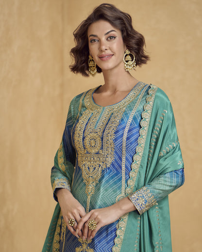 Woman wearing a traditional embroidered outfit with gold detailing on a beige background