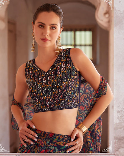 Woman wearing a traditional outfit with intricate patterns in an indoor setting