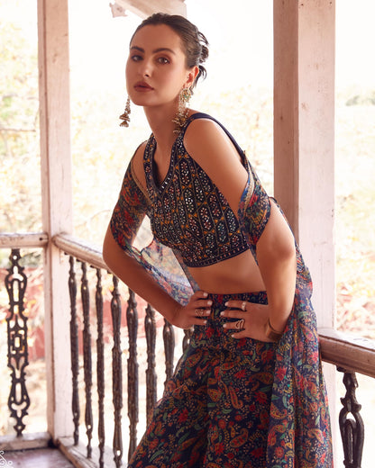 Woman wearing a colorful traditional outfit on a balcony
