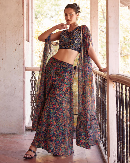 Woman in a floral traditional outfit standing on a wooden deck.