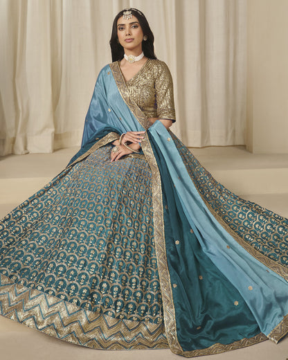 Woman wearing a traditional blue and gold saree with a plain background