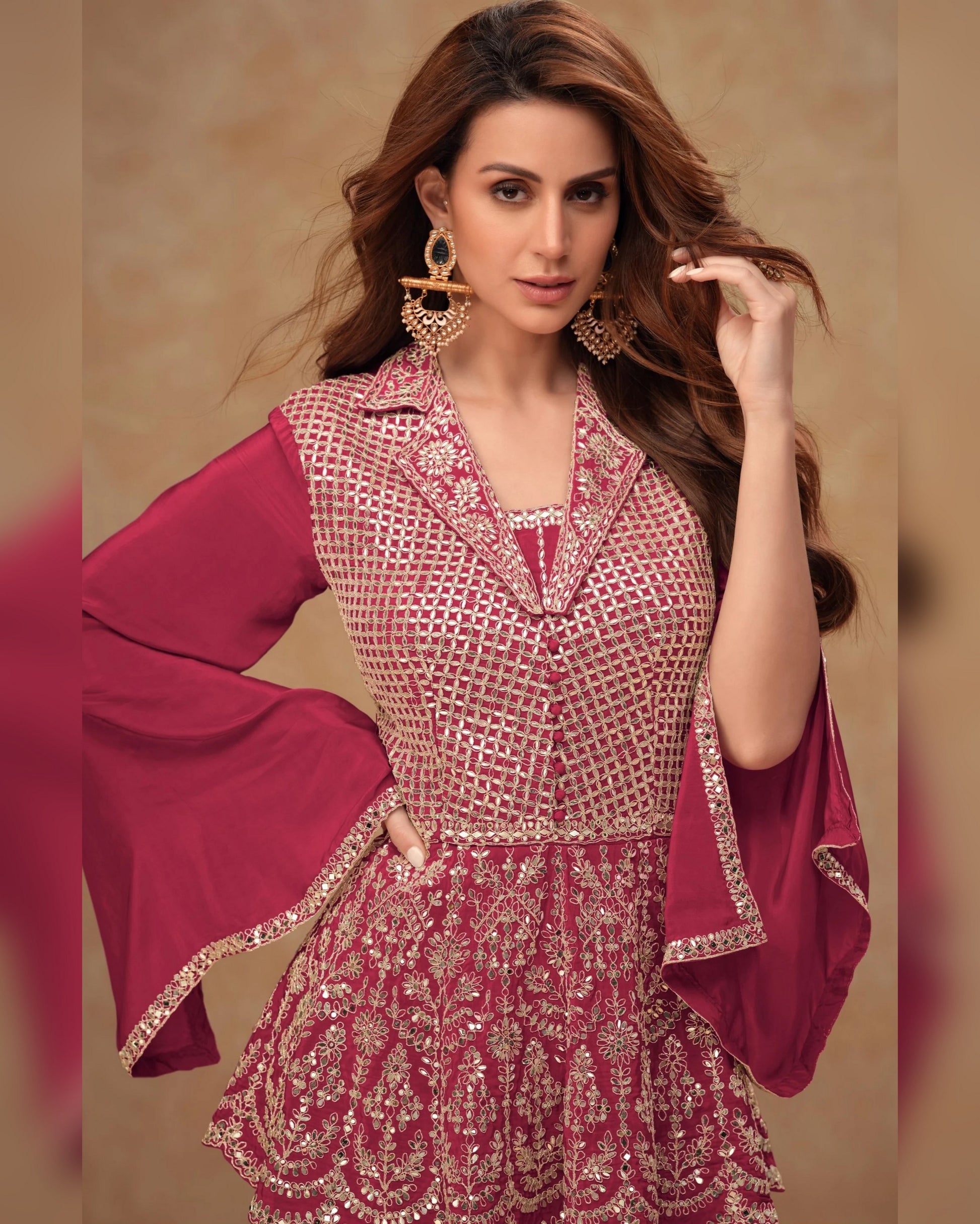 Woman wearing a traditional outfit with a pink dupatta against a beige background