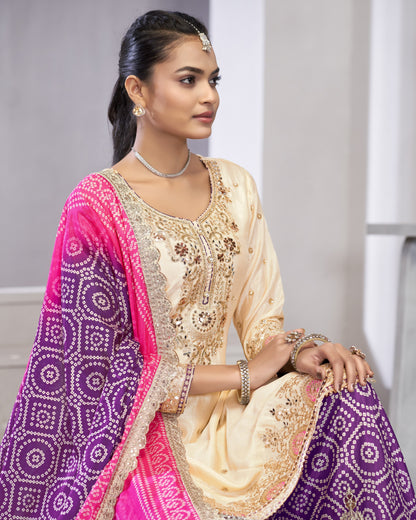 Woman wearing a traditional outfit with a pink and purple dupatta against a neutral background