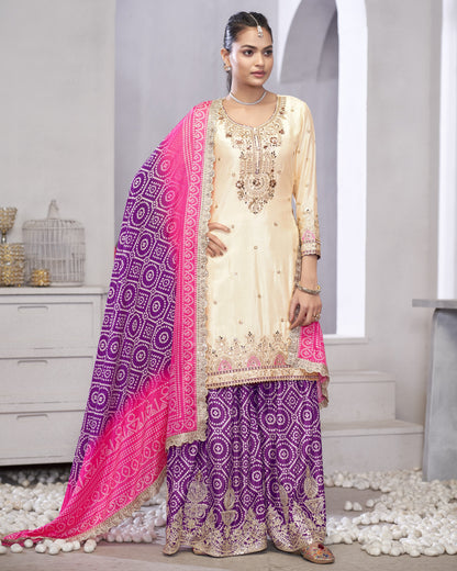 Woman wearing a traditional outfit with a pink and purple dupatta in a minimalistic setting.
