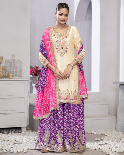 Woman wearing a traditional outfit with a pink and purple dupatta in a minimalistic setting.