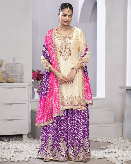 Woman wearing a traditional outfit with a pink and purple dupatta in a minimalistic setting.