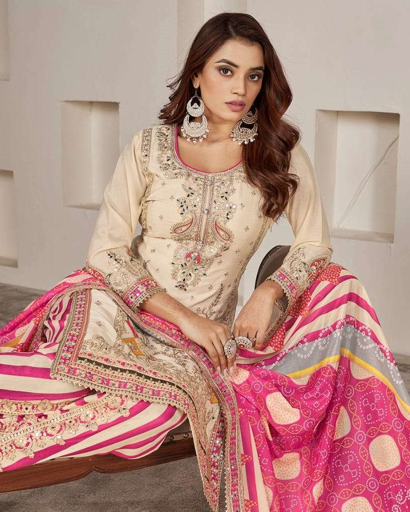 Woman wearing a traditional outfit with intricate embroidery and a pink skirt.