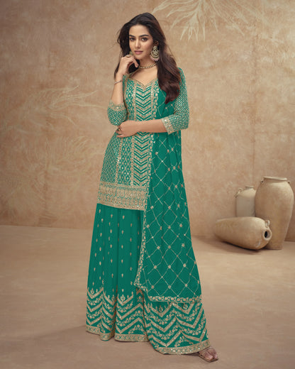 Woman wearing a green embroidered traditional outfit against a beige background