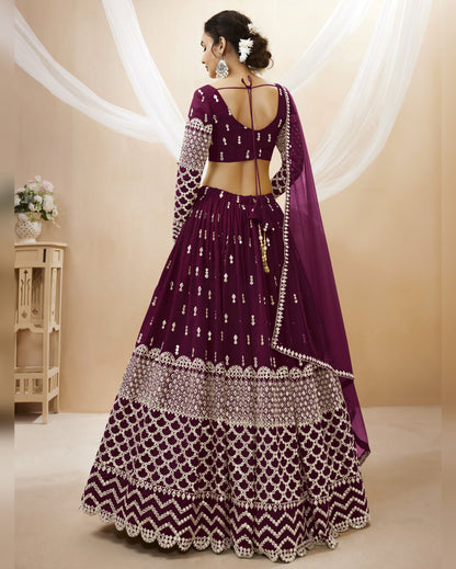 Purple traditional outfit with intricate patterns on a beige background