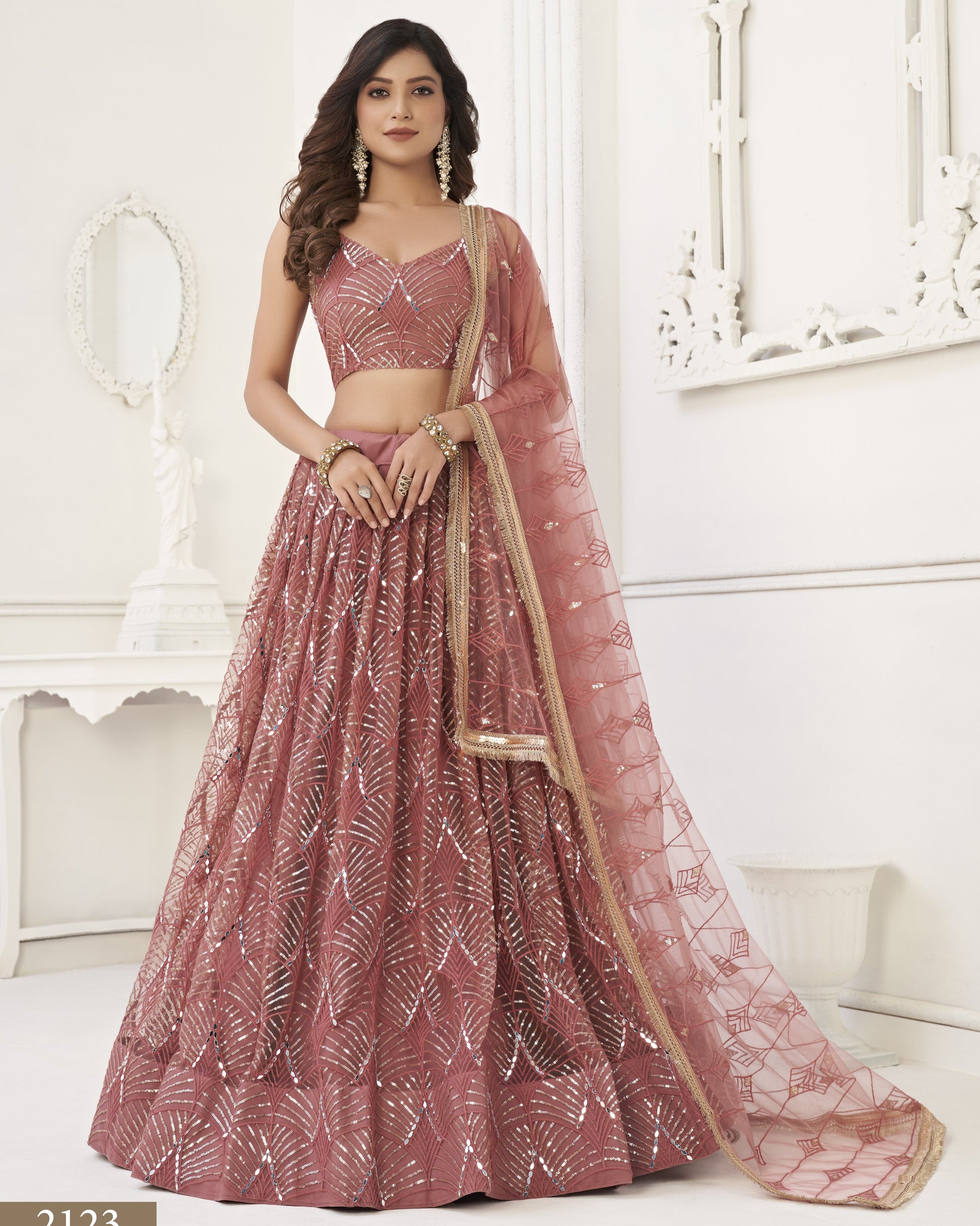 Woman wearing a pink traditional outfit with a white background