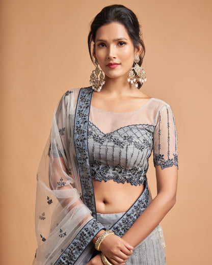 Woman wearing a traditional saree with a beige background