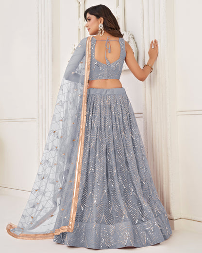 Woman wearing a gray traditional outfit with a white background