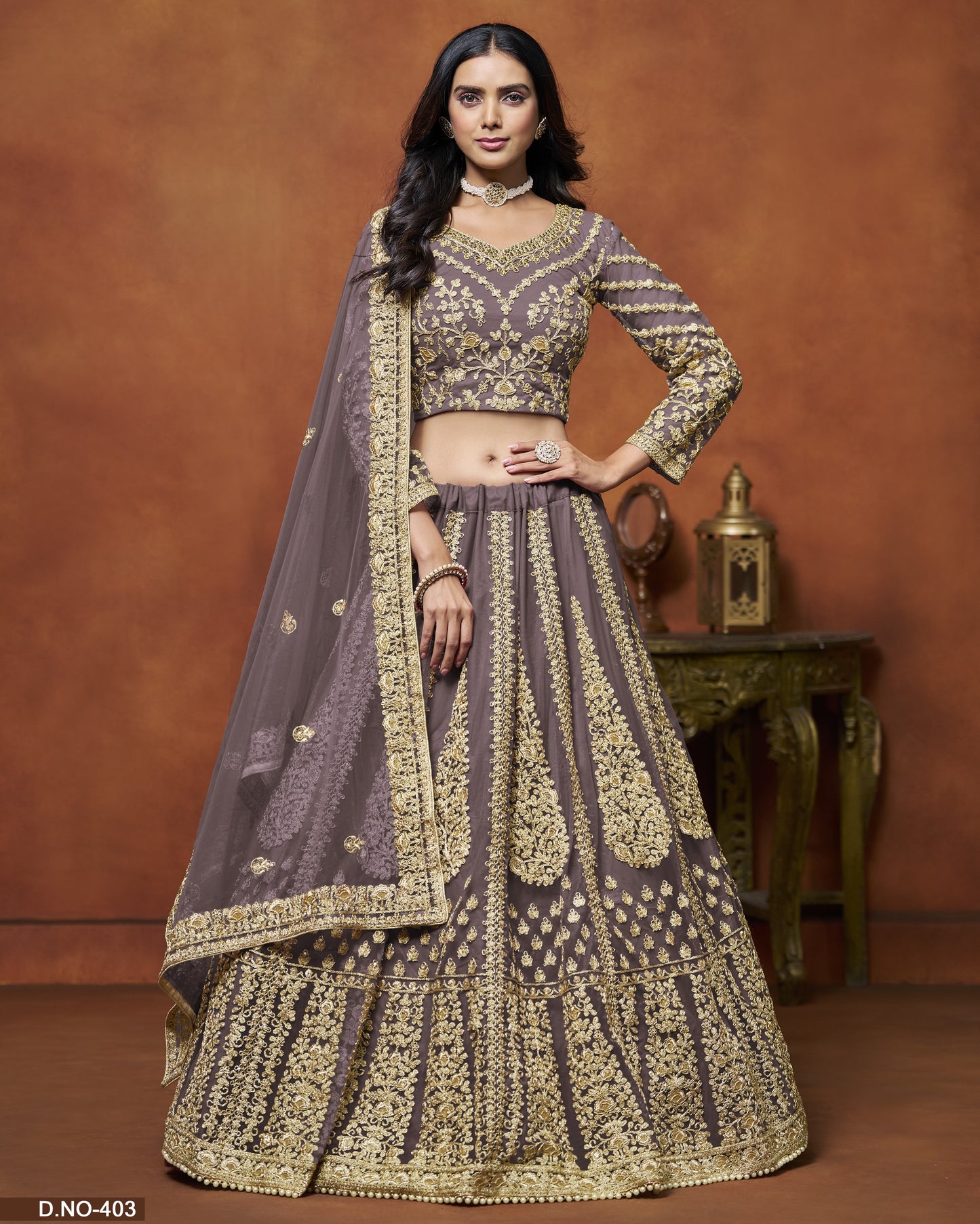 Woman wearing a traditional outfit with intricate designs on a brown background