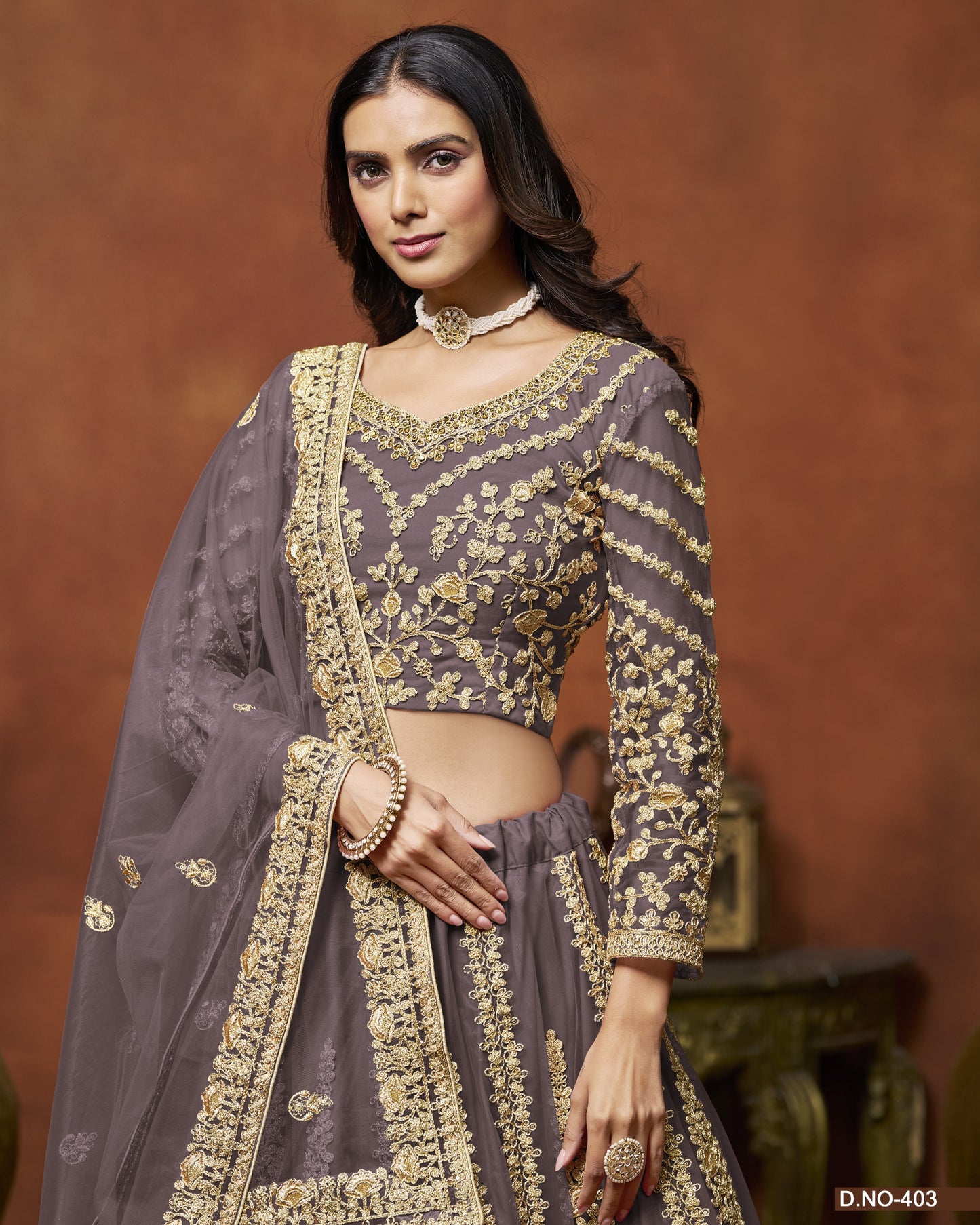 Woman wearing a traditional embroidered outfit with a brown background