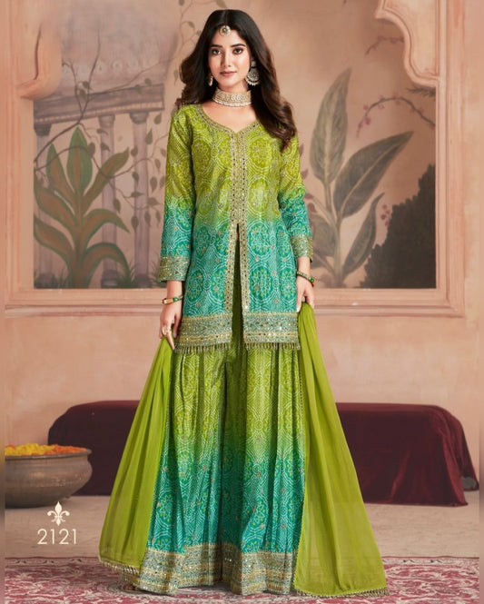 Woman wearing a green and blue traditional outfit with a decorative background