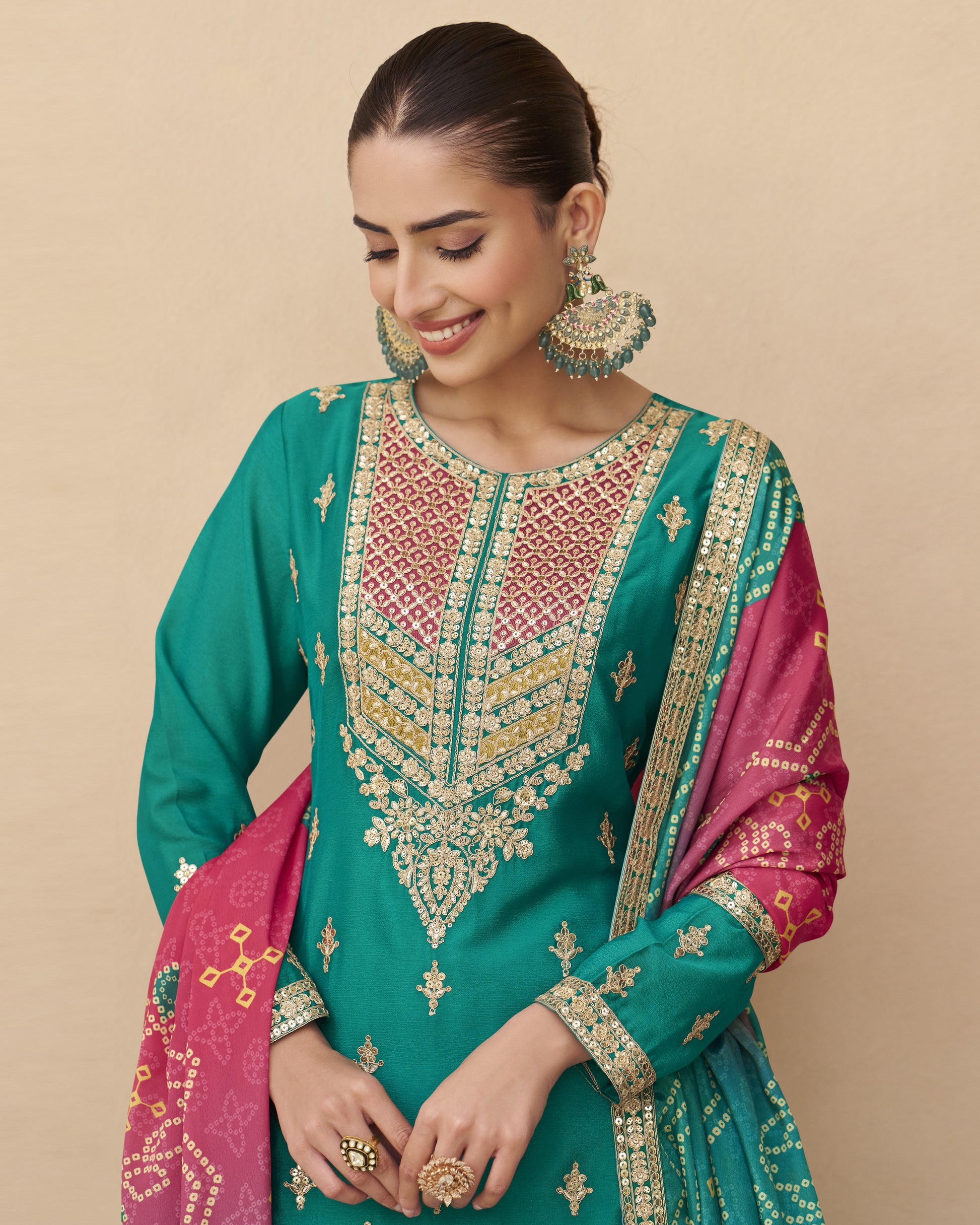 Woman wearing a traditional embroidered outfit with a beige background