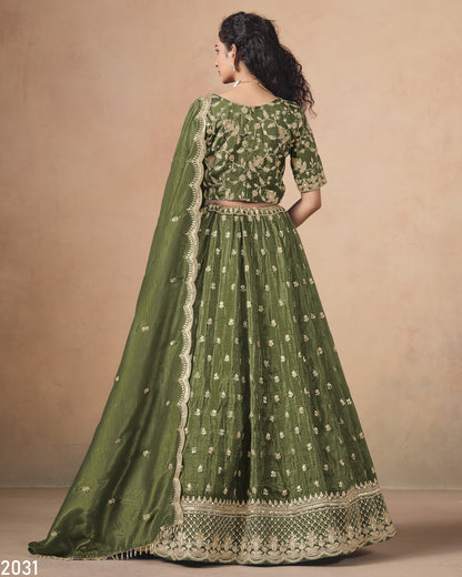 Green embroidered traditional outfit with a matching dupatta on a beige background