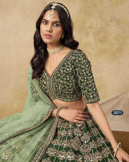 Woman wearing a green embroidered traditional outfit with jewelry against a beige background