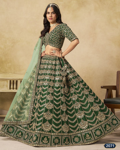 Woman wearing a green and silver embroidered traditional outfit with a beige background