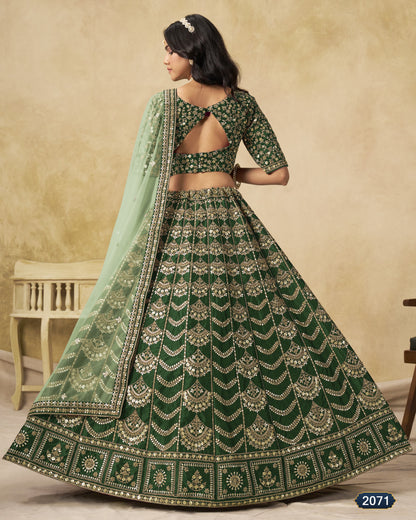 Woman wearing a green embroidered lehenga with a matching dupatta against a beige background