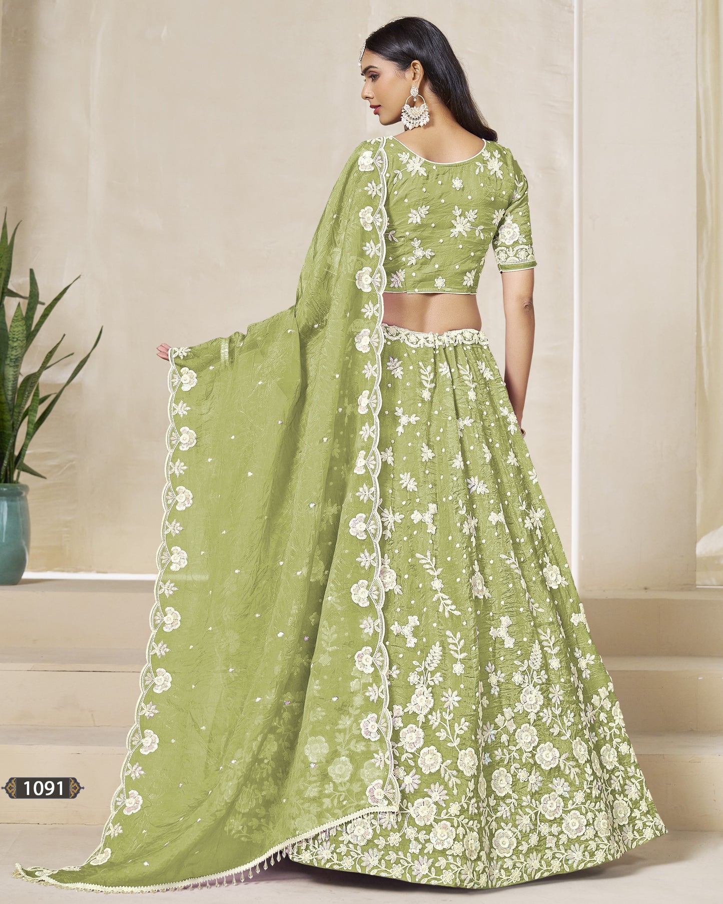 Green floral saree with matching blouse on a neutral background