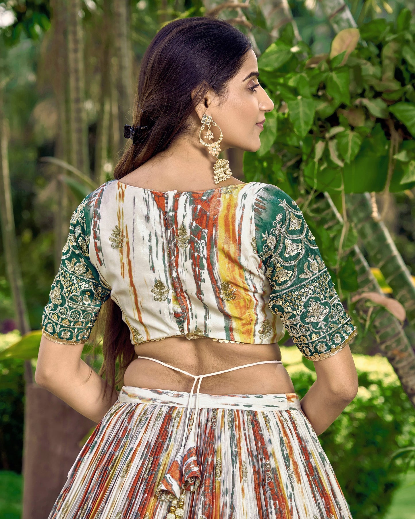 Woman wearing a patterned outfit with a blurred natural background