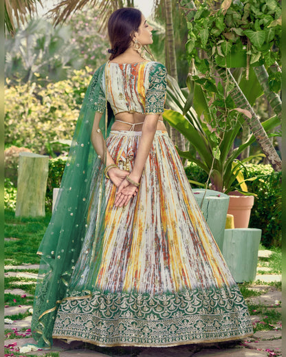 Woman in a traditional multicolored outfit with a green dupatta in a garden setting
