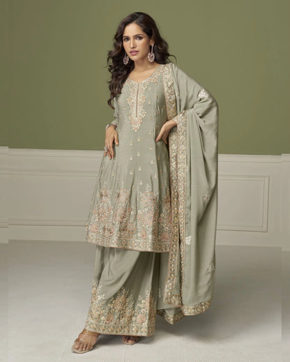 Woman wearing a traditional outfit with embroidery in a minimalistic setting