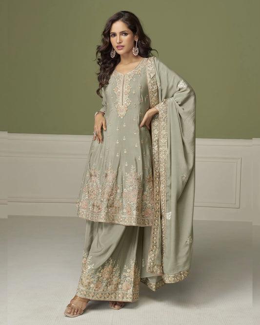 Woman wearing a traditional outfit with embroidery in a minimalistic setting