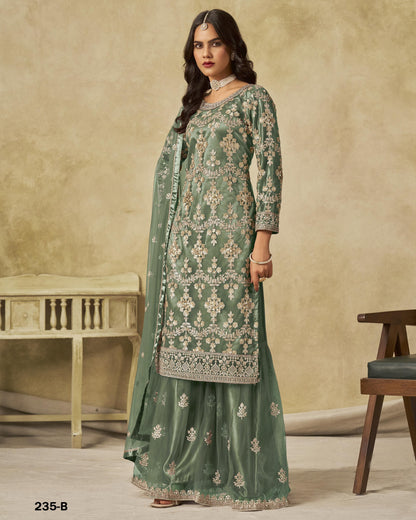 Woman wearing a green embroidered traditional outfit with a beige background